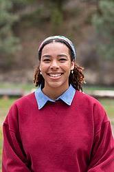 young woman in front of green background